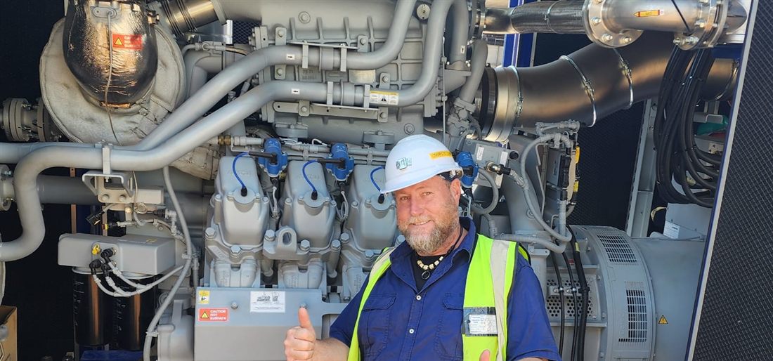 Mauritz Lindeque on site in front of a large gas generator set